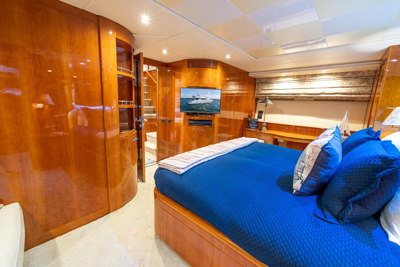 a room with a bed and a wood cabinet aboard ENDLESS SUN Yacht for Sale