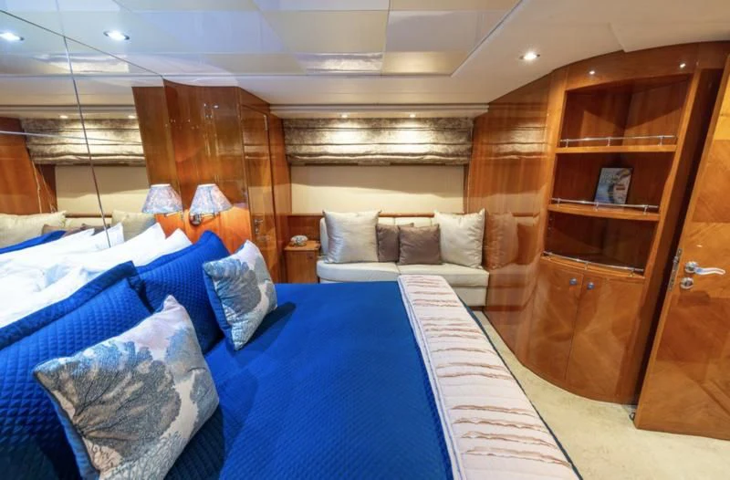 a room with a bed and a wood cabinet aboard ENDLESS SUN Yacht for Sale