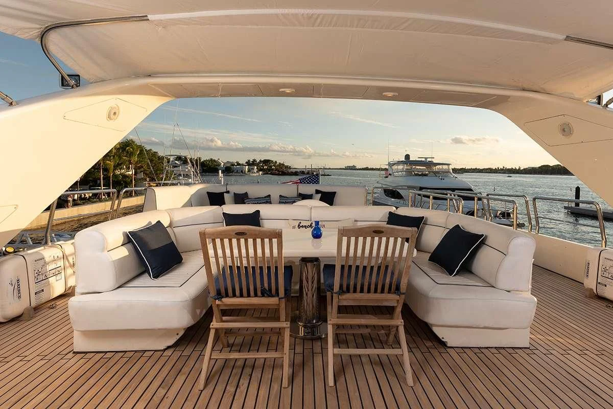 a patio with a table and chairs on it aboard ENDLESS SUN Yacht for Sale