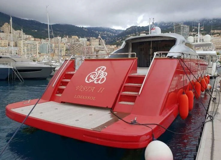 a red boat in a harbor aboard VISTA II Yacht for Sale