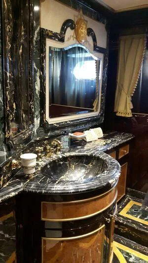 a fireplace with a large mirror aboard VISTA II Yacht for Sale