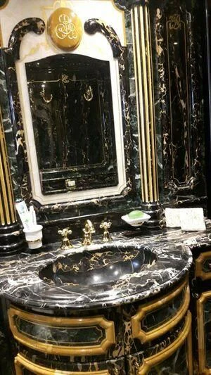 a gold framed picture on a table aboard VISTA II Yacht for Sale