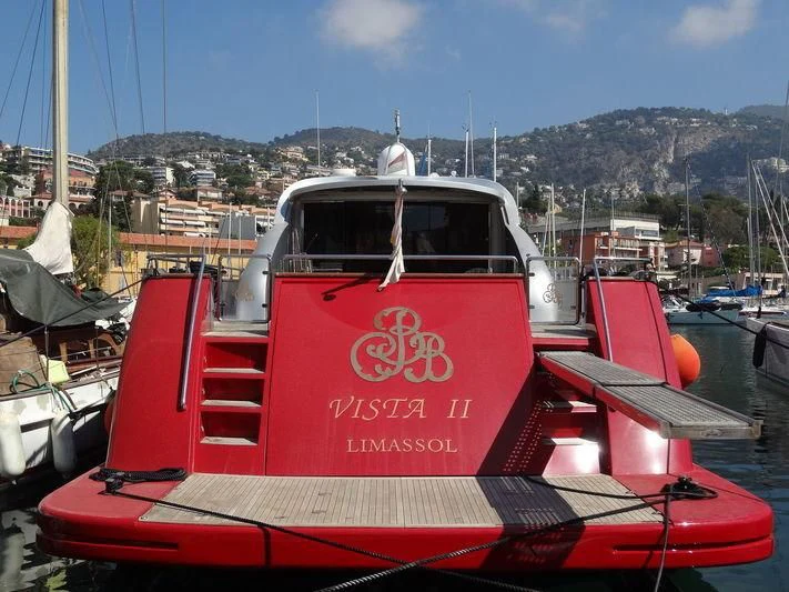 a red boat in a harbor aboard VISTA II Yacht for Sale