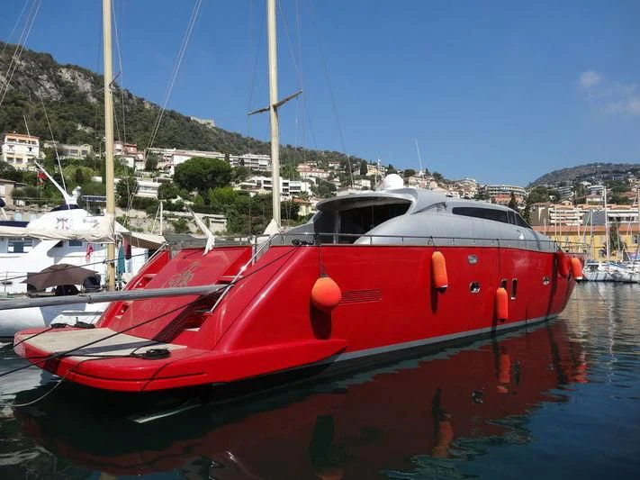 a red boat in a harbor aboard VISTA II Yacht for Sale