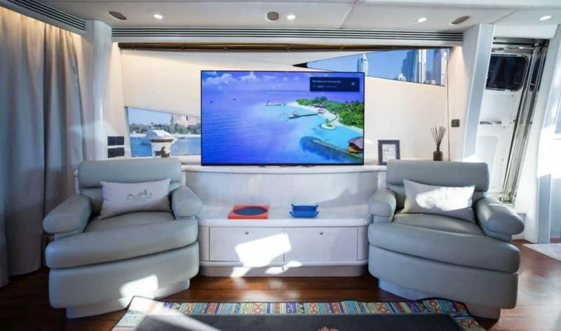 a living room with a large screen aboard UD30 Yacht for Sale