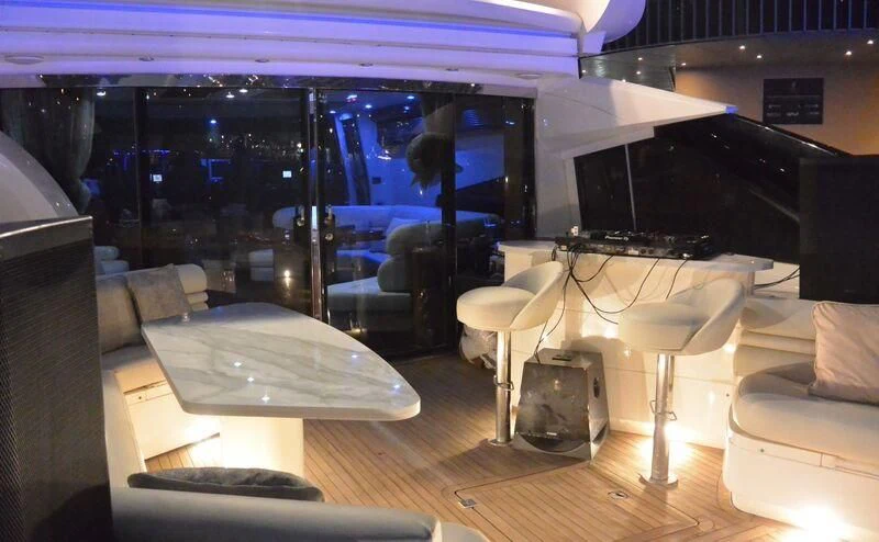 a room with a table and chairs aboard UD30 Yacht for Sale