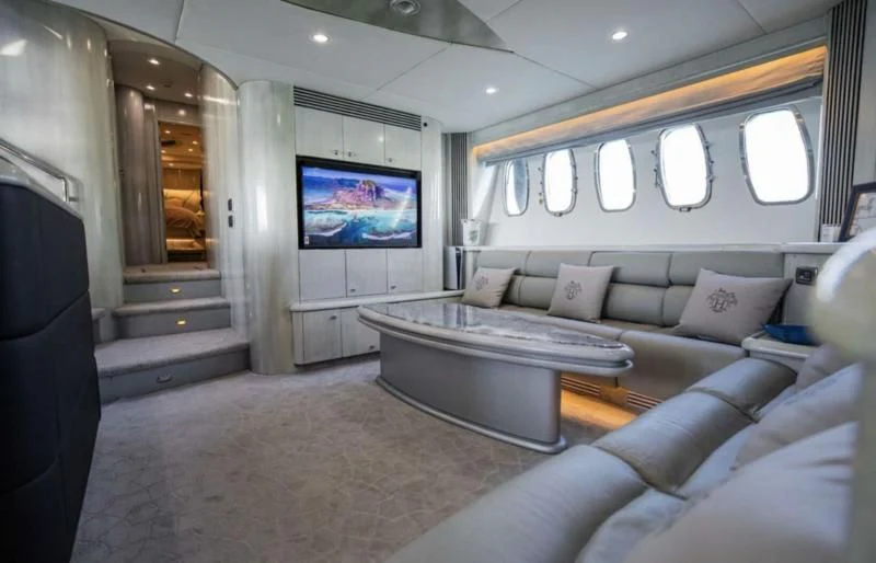 a living room with a large sofa aboard UD30 Yacht for Sale