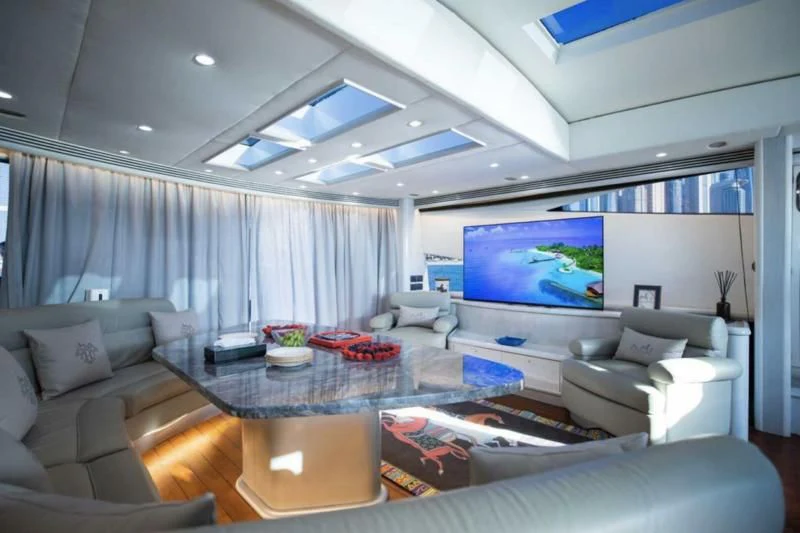 a living room with a large screen aboard UD30 Yacht for Sale