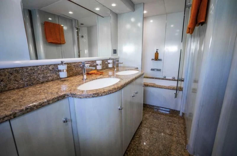 a bathroom with a countertop sink and a large mirror aboard UD30 Yacht for Sale