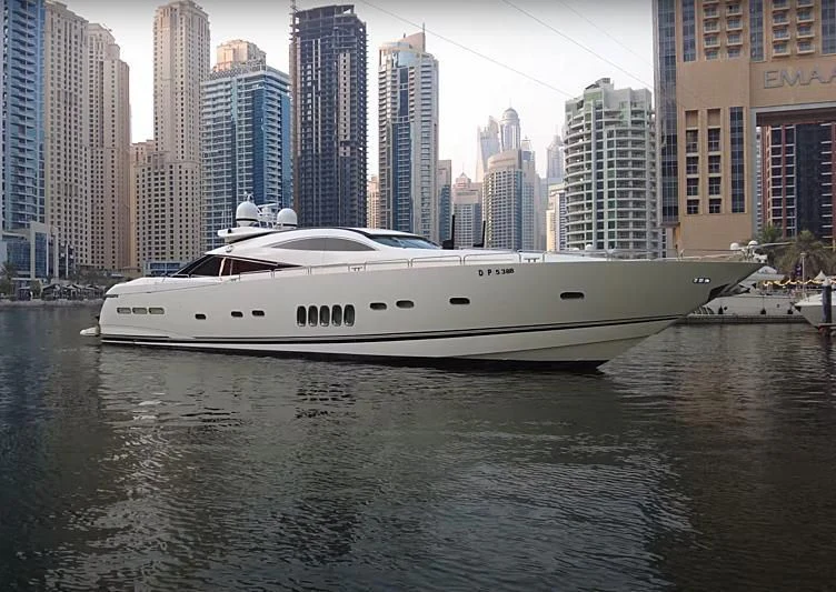 a white yacht in a body of water with a city in the background aboard UD30 Yacht for Sale