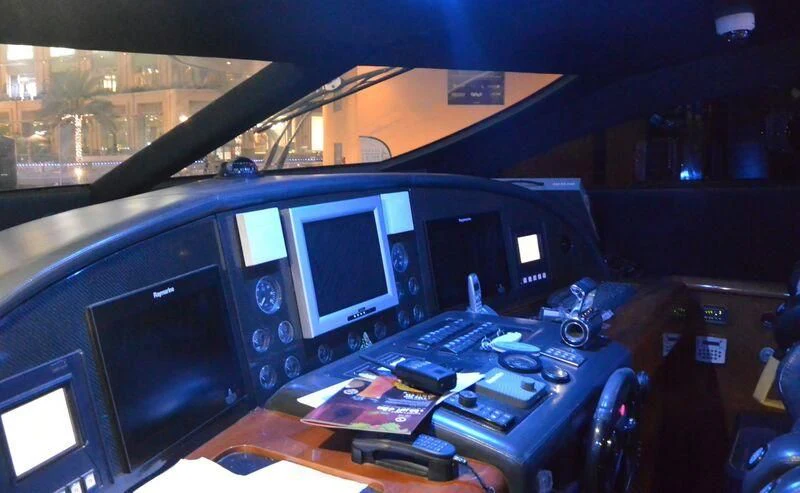 a computer desk with multiple monitors aboard UD30 Yacht for Sale