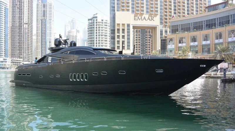 a black boat on water aboard UD30 Yacht for Sale