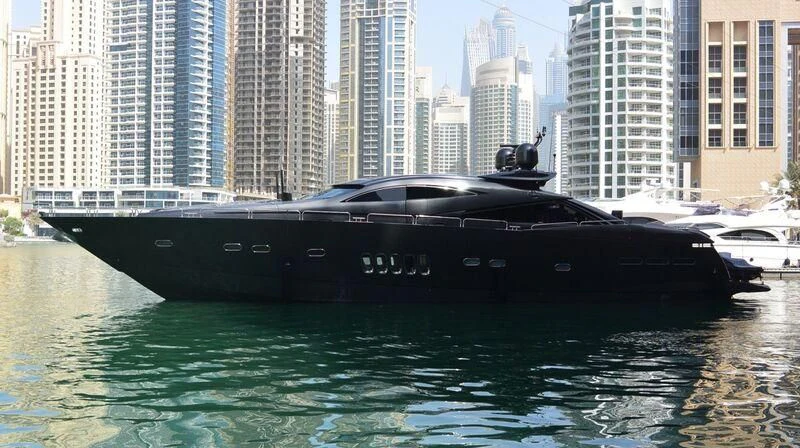 a black boat on water aboard UD30 Yacht for Sale