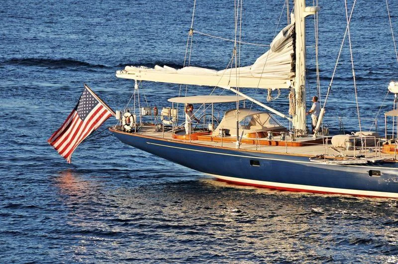 a boat with a flag on it aboard REBECCA Yacht for Sale