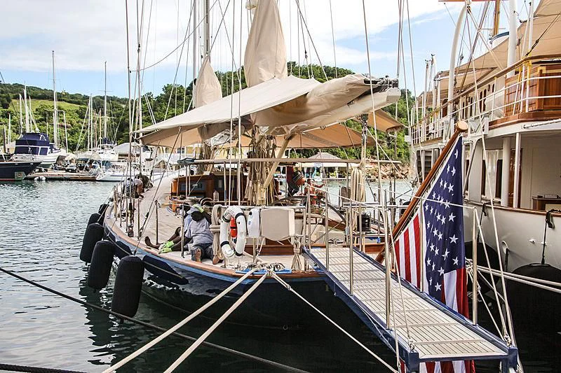 a boat with a flag on it aboard REBECCA Yacht for Sale