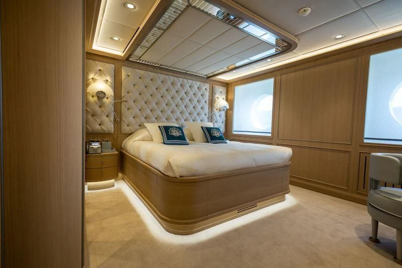 a bedroom with a bed and a window aboard DREAM Yacht for Sale