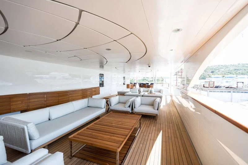 a large living room with a wood floor aboard DREAM Yacht for Sale