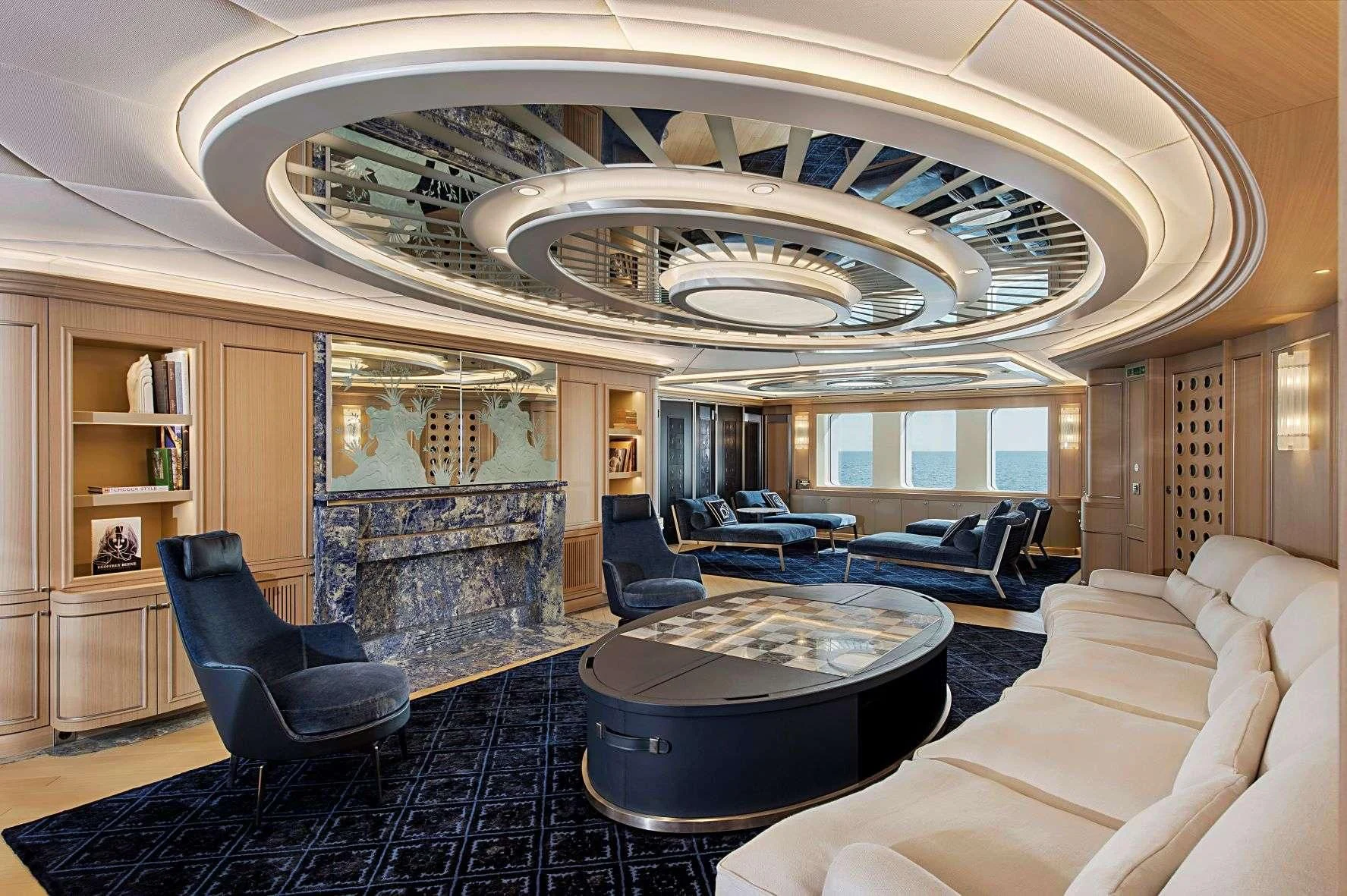 a living room with a fireplace aboard DREAM Yacht for Sale