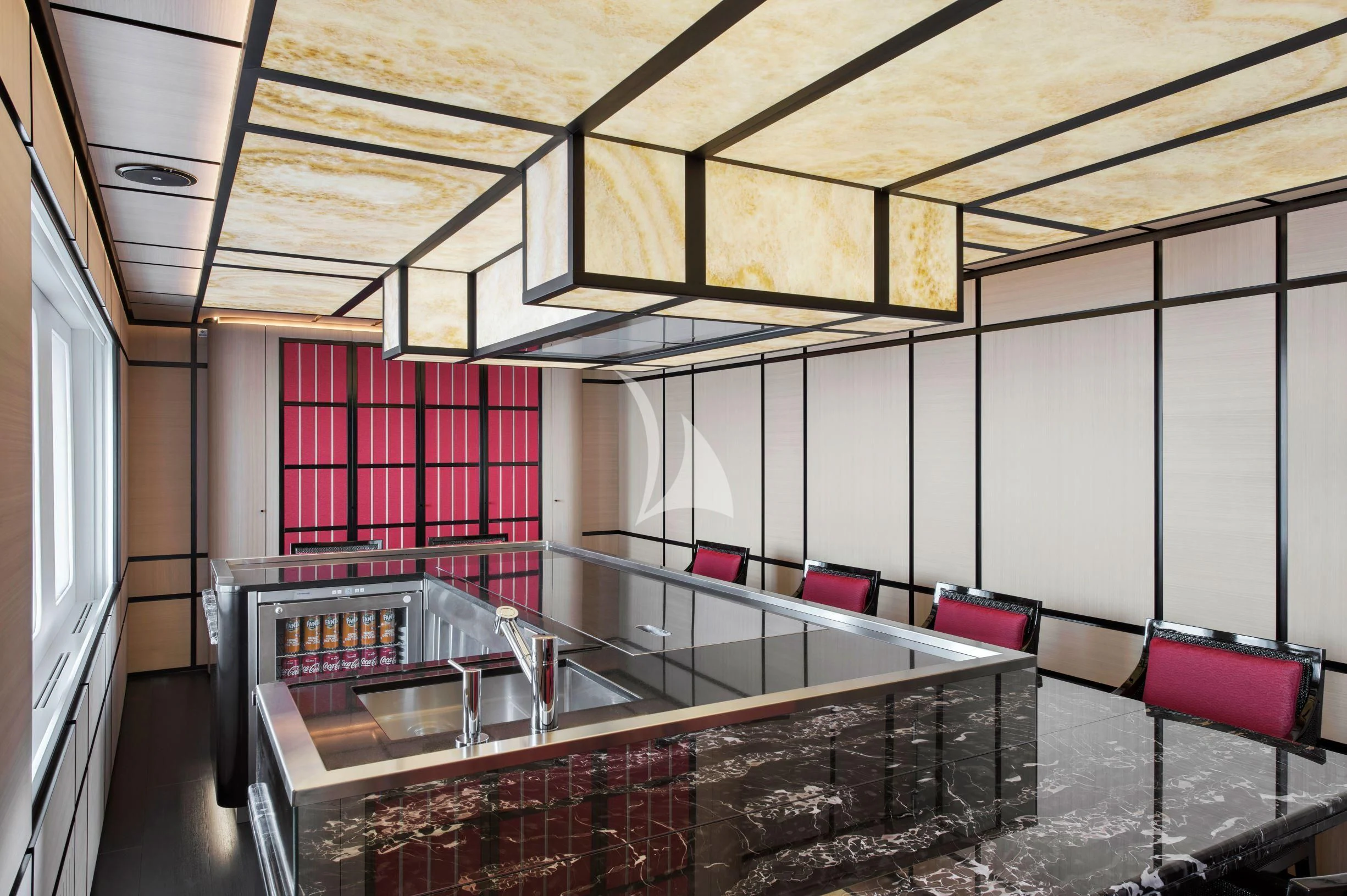 a room with a large glass display case and a table with chairs aboard DREAM Yacht for Sale