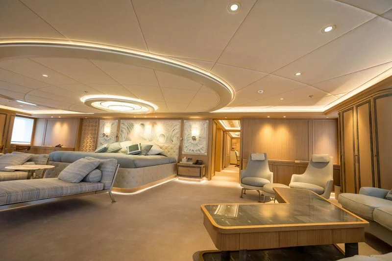 a room with a table and couches aboard DREAM Yacht for Sale