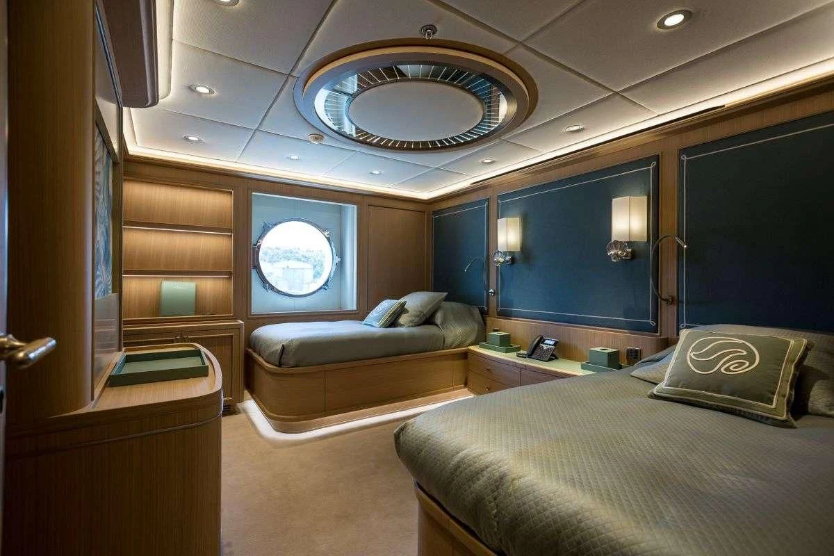 a room with a bed and a couch aboard DREAM Yacht for Sale