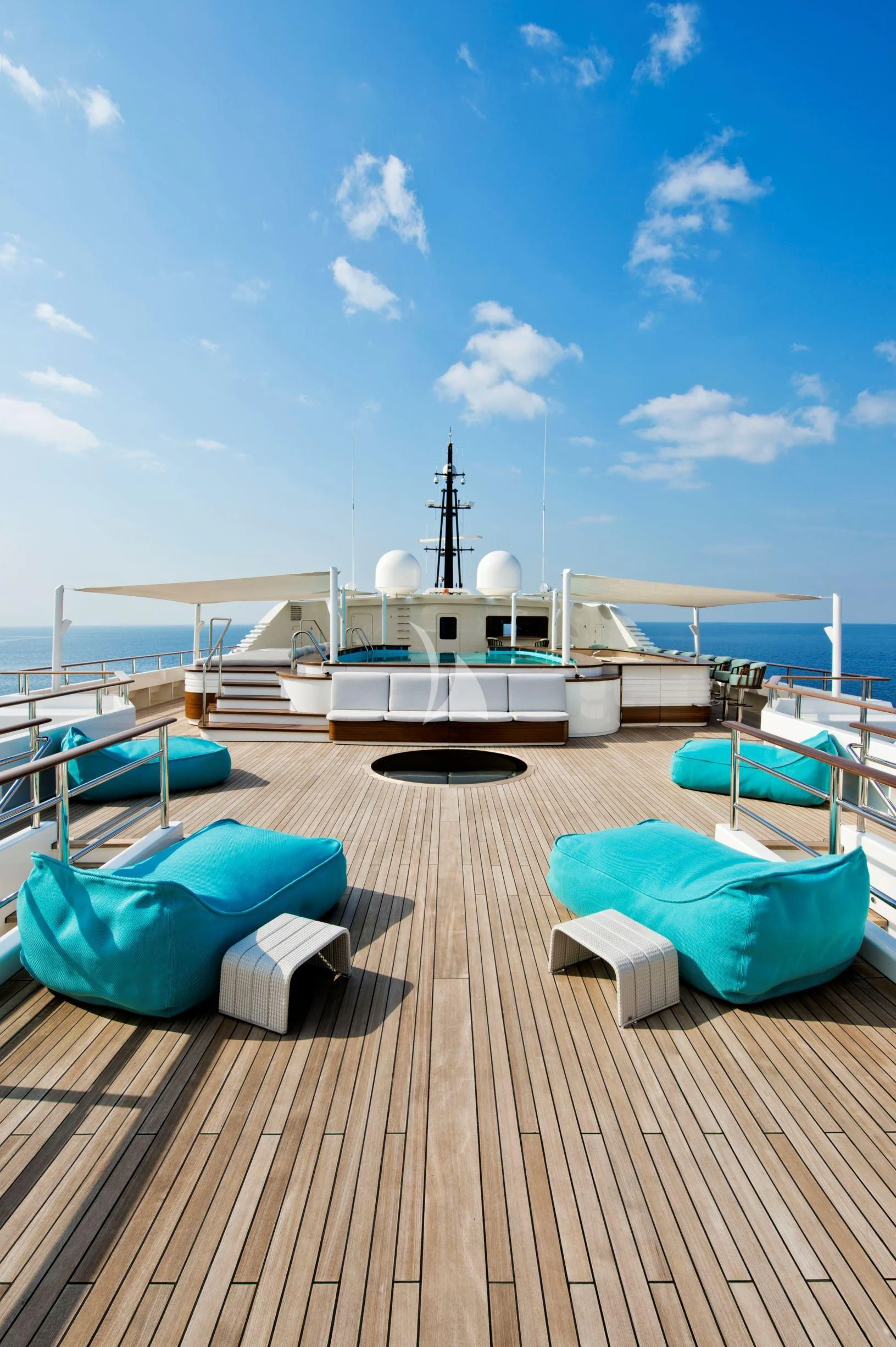 a deck with a boat and chairs on it aboard DREAM Yacht for Sale