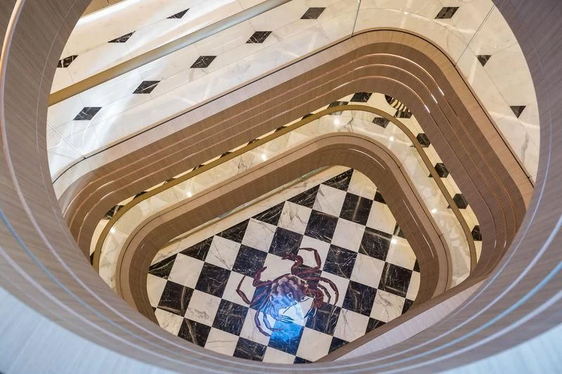 a circular staircase with a painting on the wall aboard DREAM Yacht for Sale