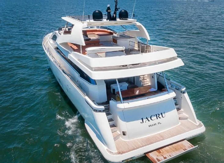 a white boat on the water aboard JACRU Yacht for Sale