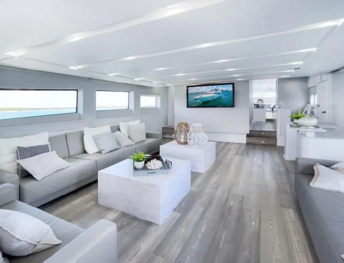 a living room with a large screen aboard JACRU Yacht for Sale
