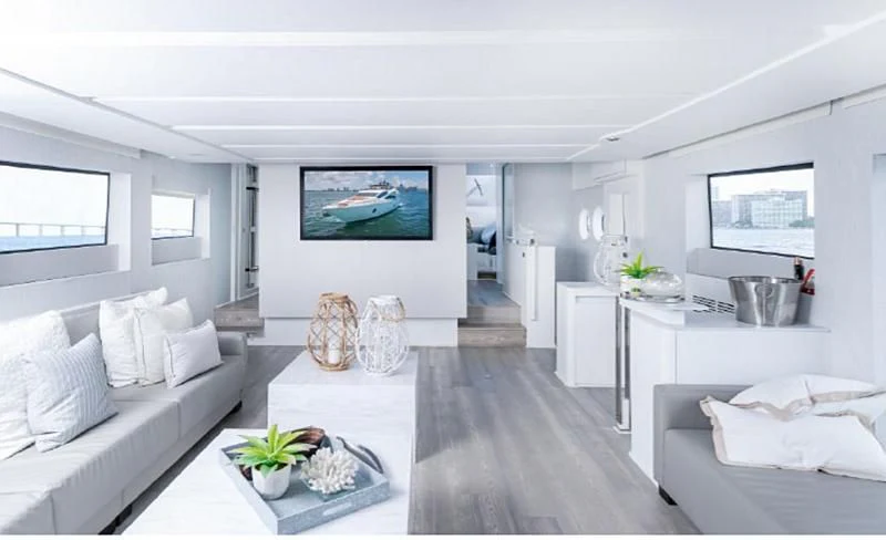 a living room with white furniture aboard JACRU Yacht for Sale