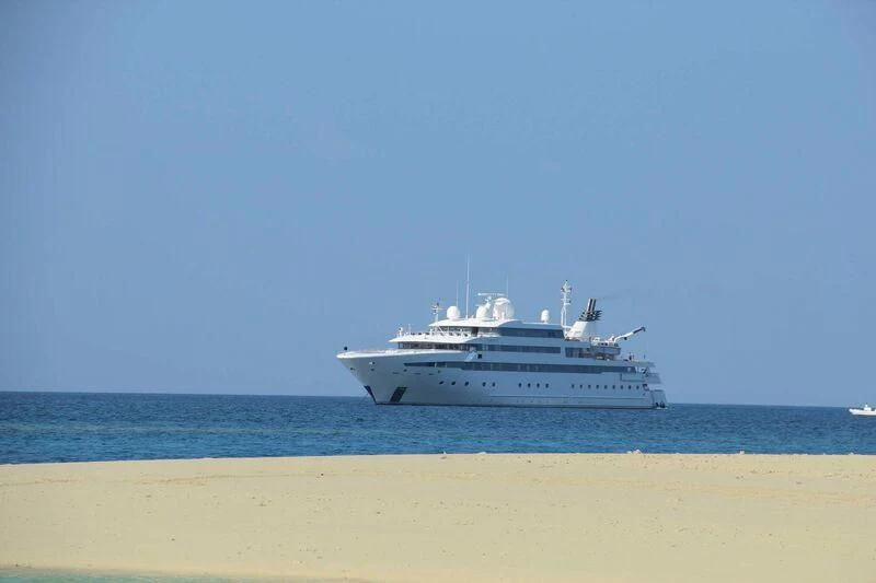 a white boat on a beach aboard LAUREN L Yacht for Sale