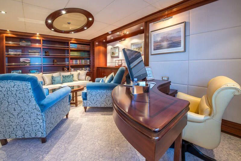 a room with a table chairs and a tv aboard LAUREN L Yacht for Sale