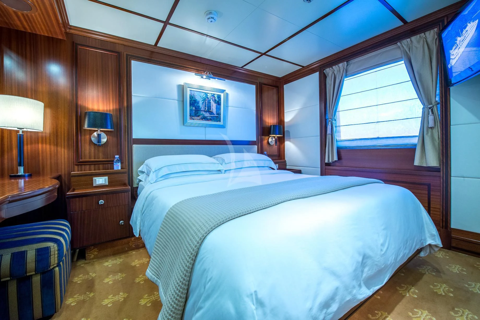 a bedroom with a bed and a window aboard LAUREN L Yacht for Sale