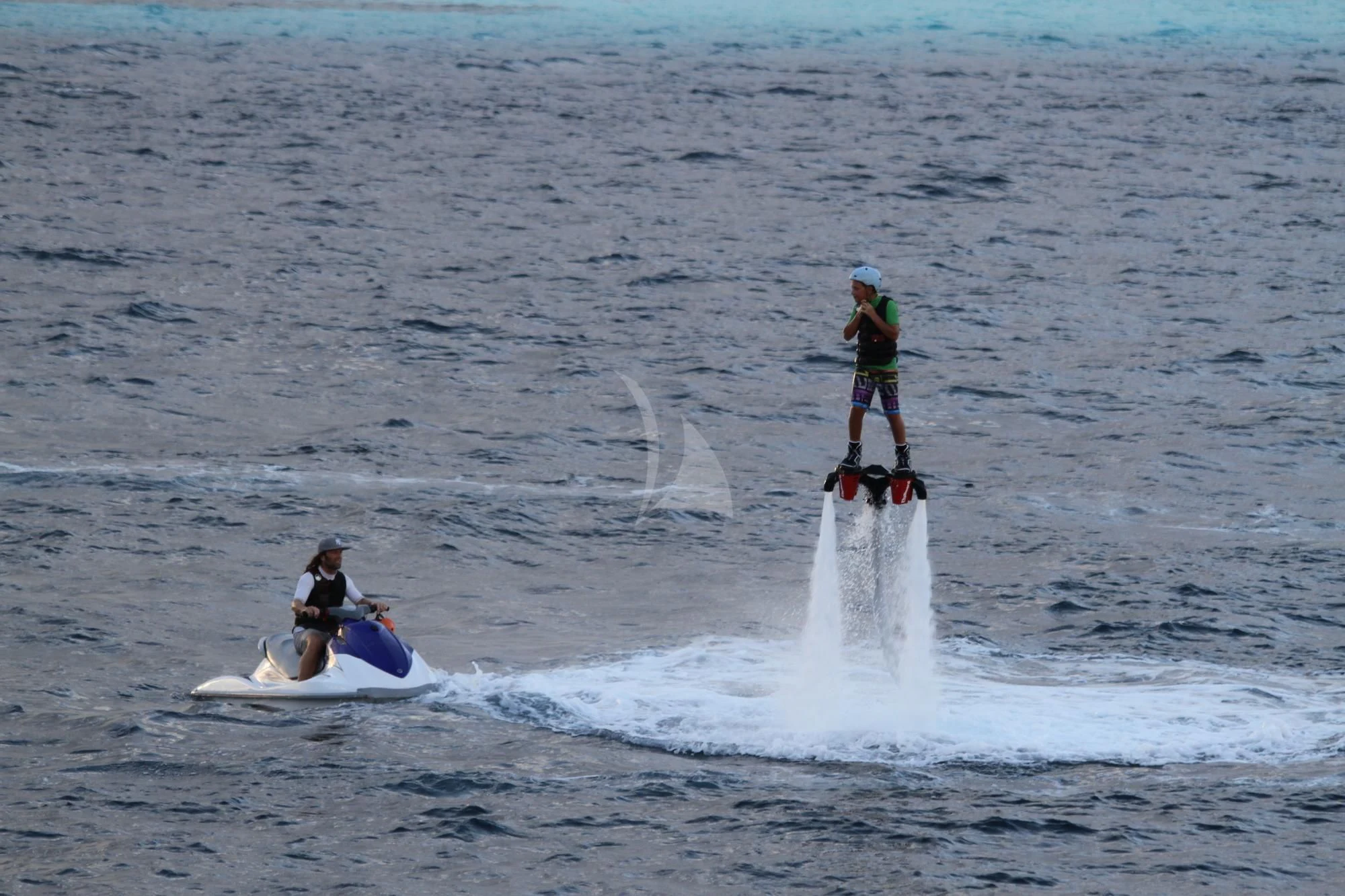 a man and a woman on a jet ski in the water aboard LAUREN L Yacht for Sale