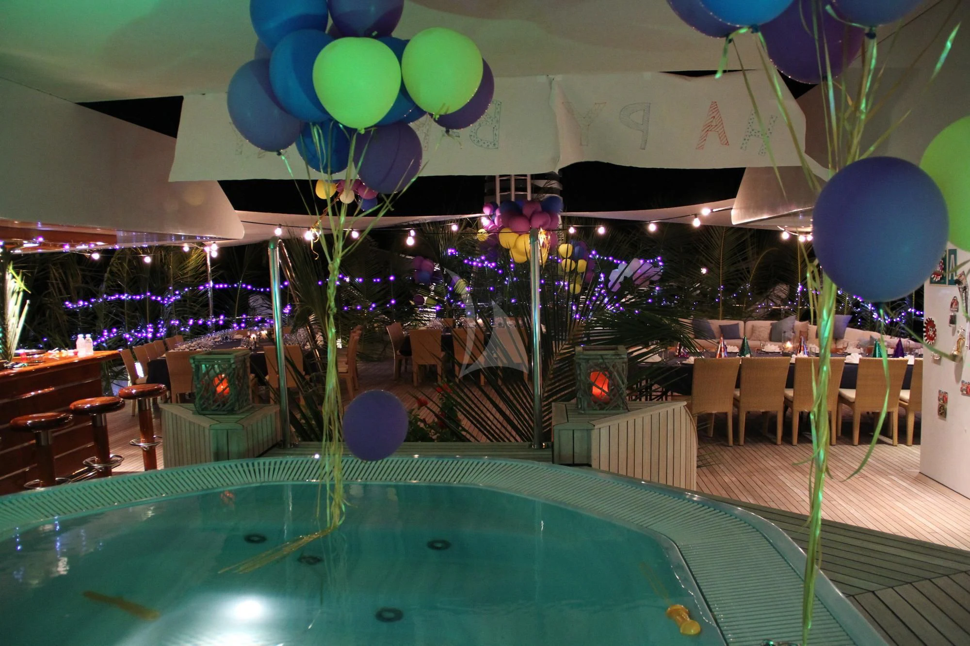 a pool with balloons and a table aboard LAUREN L Yacht for Sale