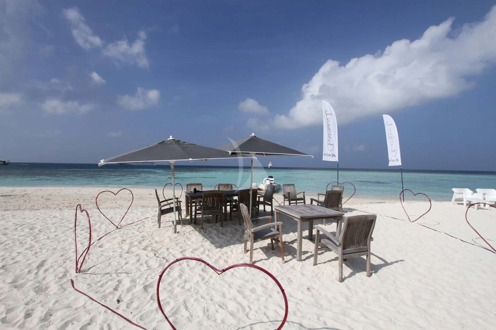 a beach with chairs and tables and umbrellas aboard LAUREN L Yacht for Sale