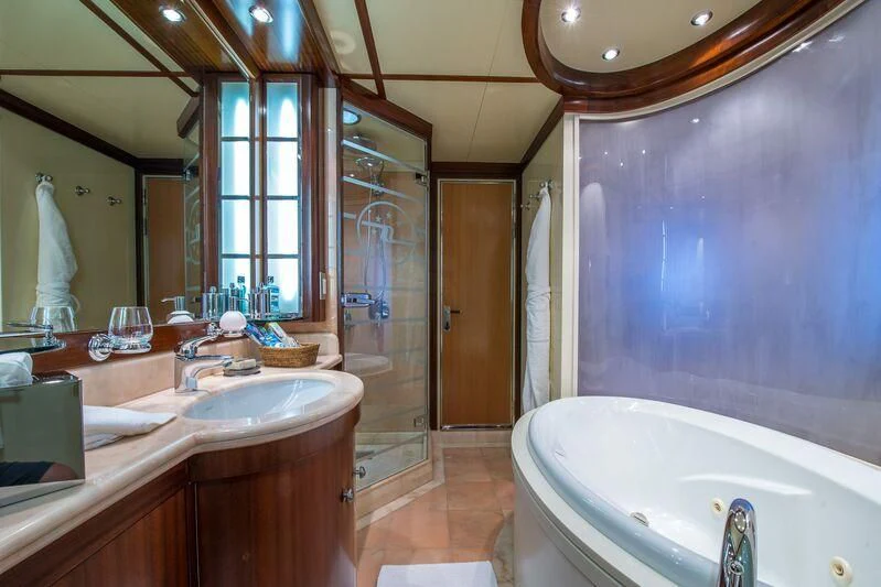 a bathroom with a large bathtub and sinks aboard LAUREN L Yacht for Sale