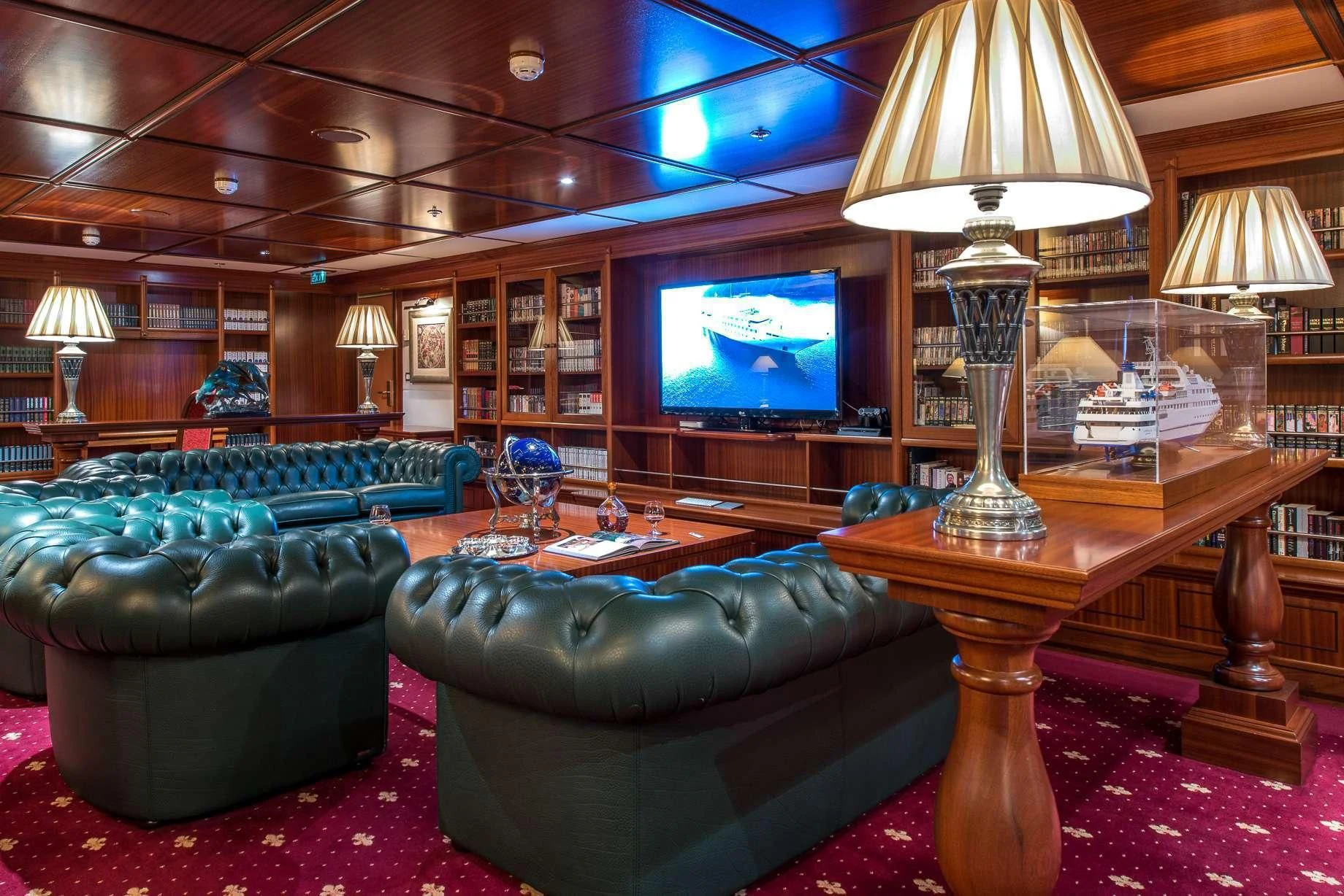 a room with a couch and a television aboard LAUREN L Yacht for Sale