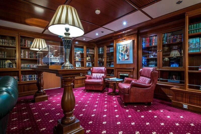 a room with a table chairs and a lamp aboard LAUREN L Yacht for Sale