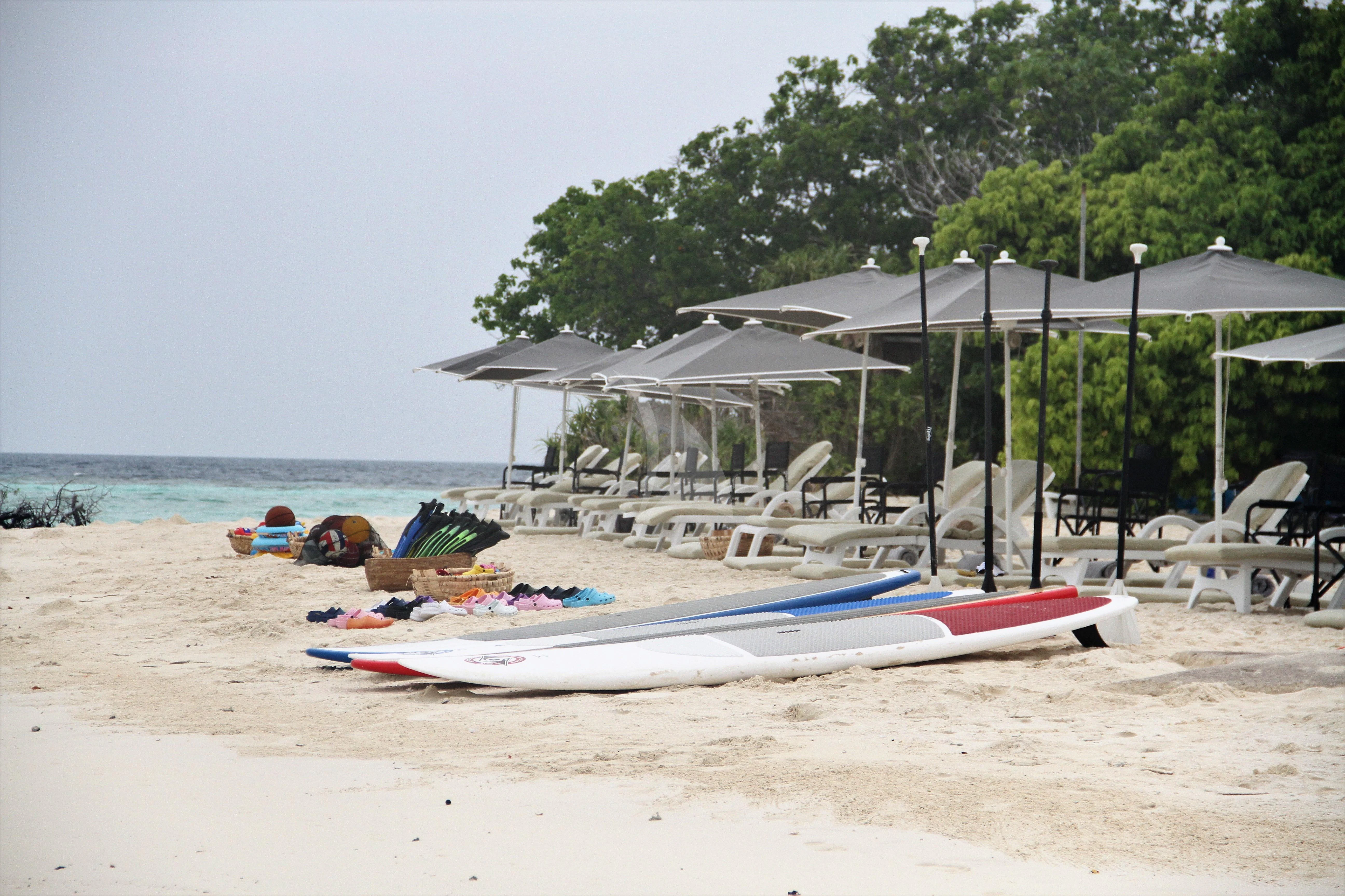 a beach with lounge chairs and umbrellas aboard LAUREN L Yacht for Sale