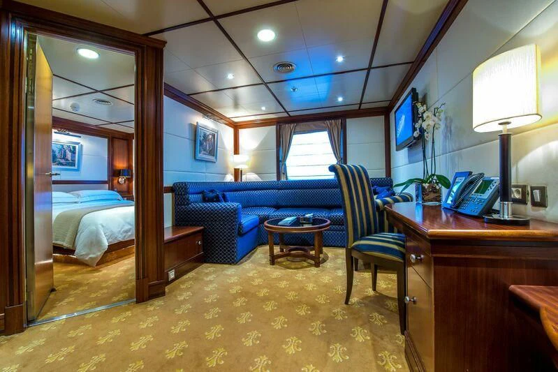 a bedroom with a bed and a desk aboard LAUREN L Yacht for Sale
