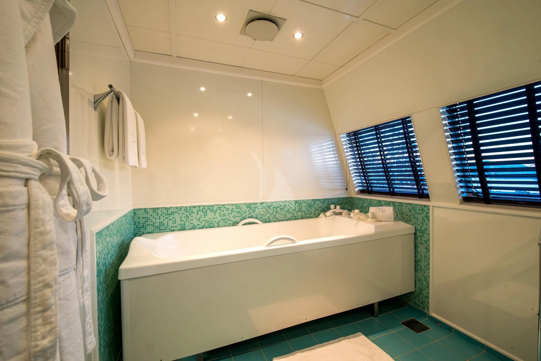 a bathroom with a bathtub and towels aboard LAUREN L Yacht for Sale