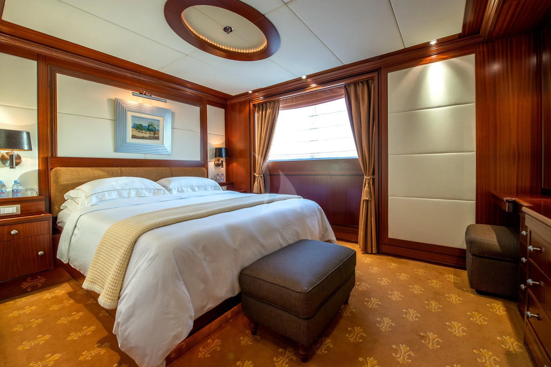 a bedroom with a bed and a chair aboard LAUREN L Yacht for Sale