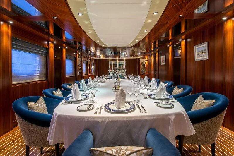 a dining room with a table set aboard LAUREN L Yacht for Sale