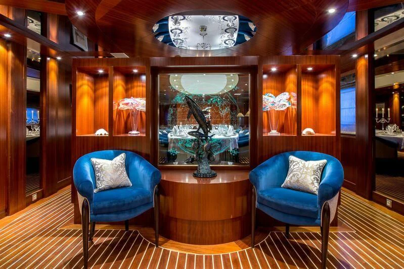 a room with a blue chair and a blue chair aboard LAUREN L Yacht for Sale