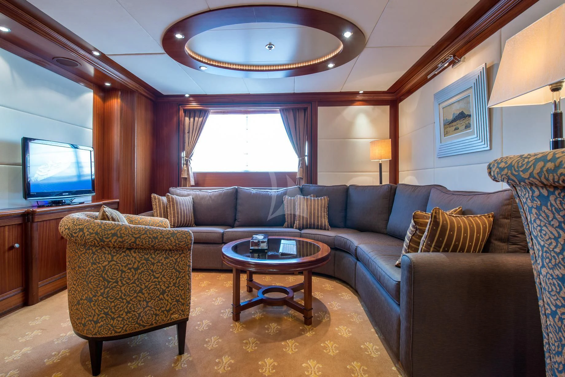 a living room with a couch and a tv aboard LAUREN L Yacht for Sale