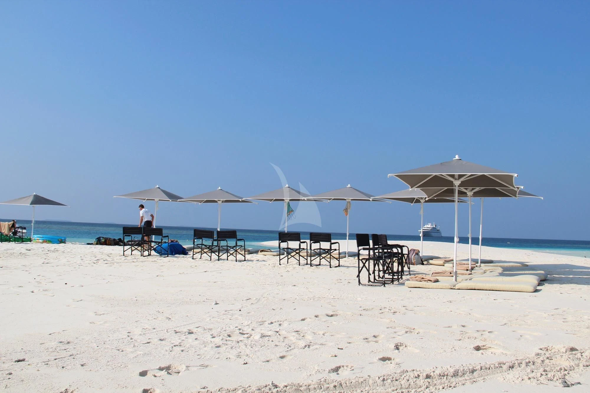 umbrellas and chairs on a beach aboard LAUREN L Yacht for Sale