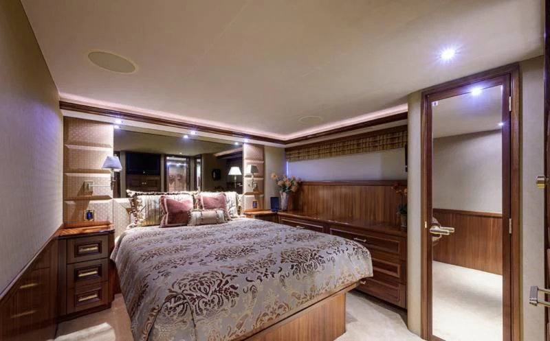 a bedroom with a bed and a closet aboard SYMPHONY Yacht for Sale