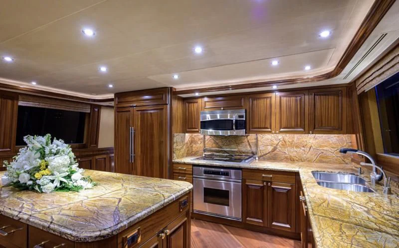 a kitchen with wooden cabinets aboard SYMPHONY Yacht for Sale