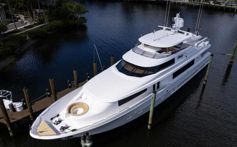 a white boat on a dock aboard SYMPHONY Yacht for Sale